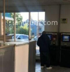 Man wearing a sweat suit at a coin-to-card machine