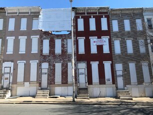 A block of three-story rowhomes boarded up